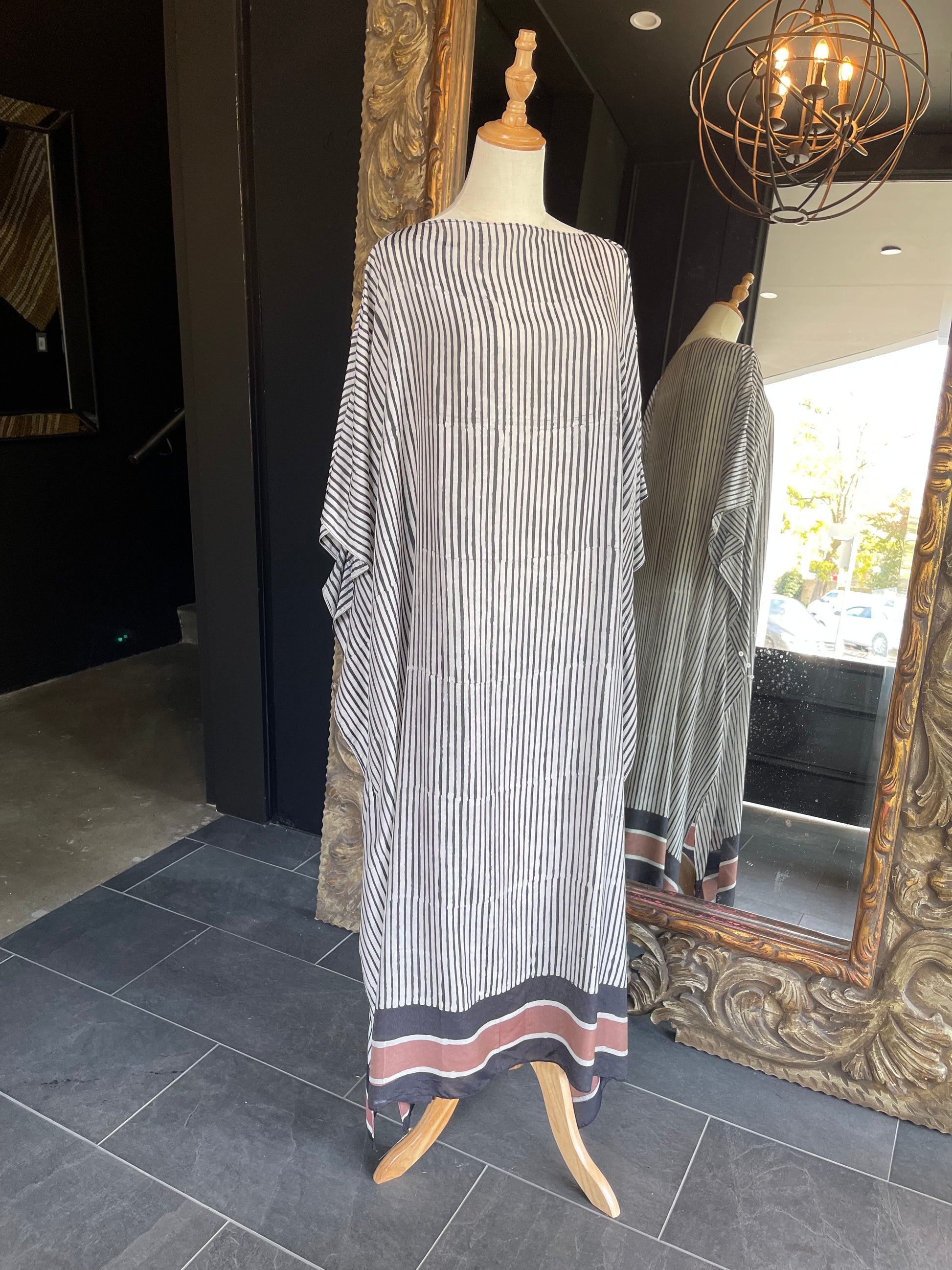 Designed by esteemed Indonesian designer Warwick Purser, this beautiful Kaftan showcases a special pattern printed by hand using the traditional Batik printing methods of East Indonesian villages. Crafted from breathable bamboo, providing lightweight comfort while making it perfect for warmer climates and travelling.