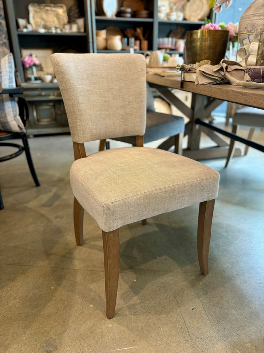 The Chelsea Dining Chair is constructed with a light grey linen finish and features stud detailing on the back for a sophisticated, yet comfortable aesthetic. Front