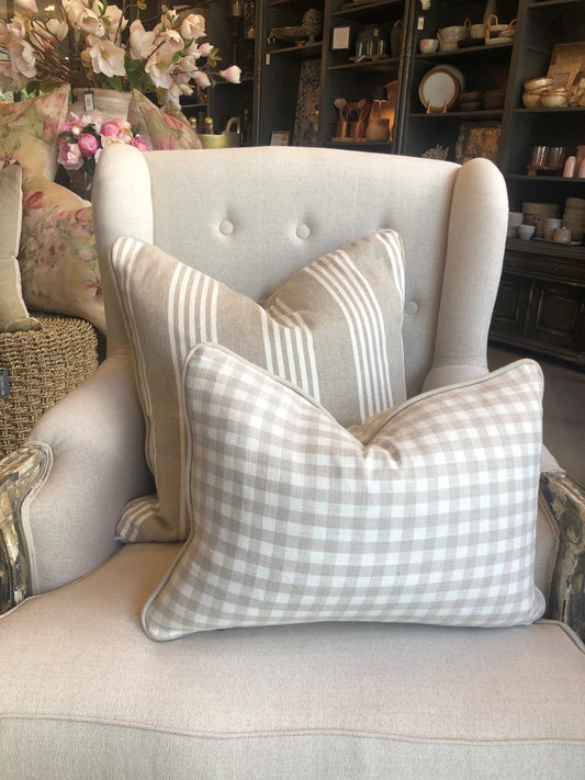 Experience unparalleled comfort with the Natural &amp; Cream Gingham Lumbar Cushion. Made from premium natural linen and filled with soft, indulgent feathers, this cushion is the epitome of luxury.