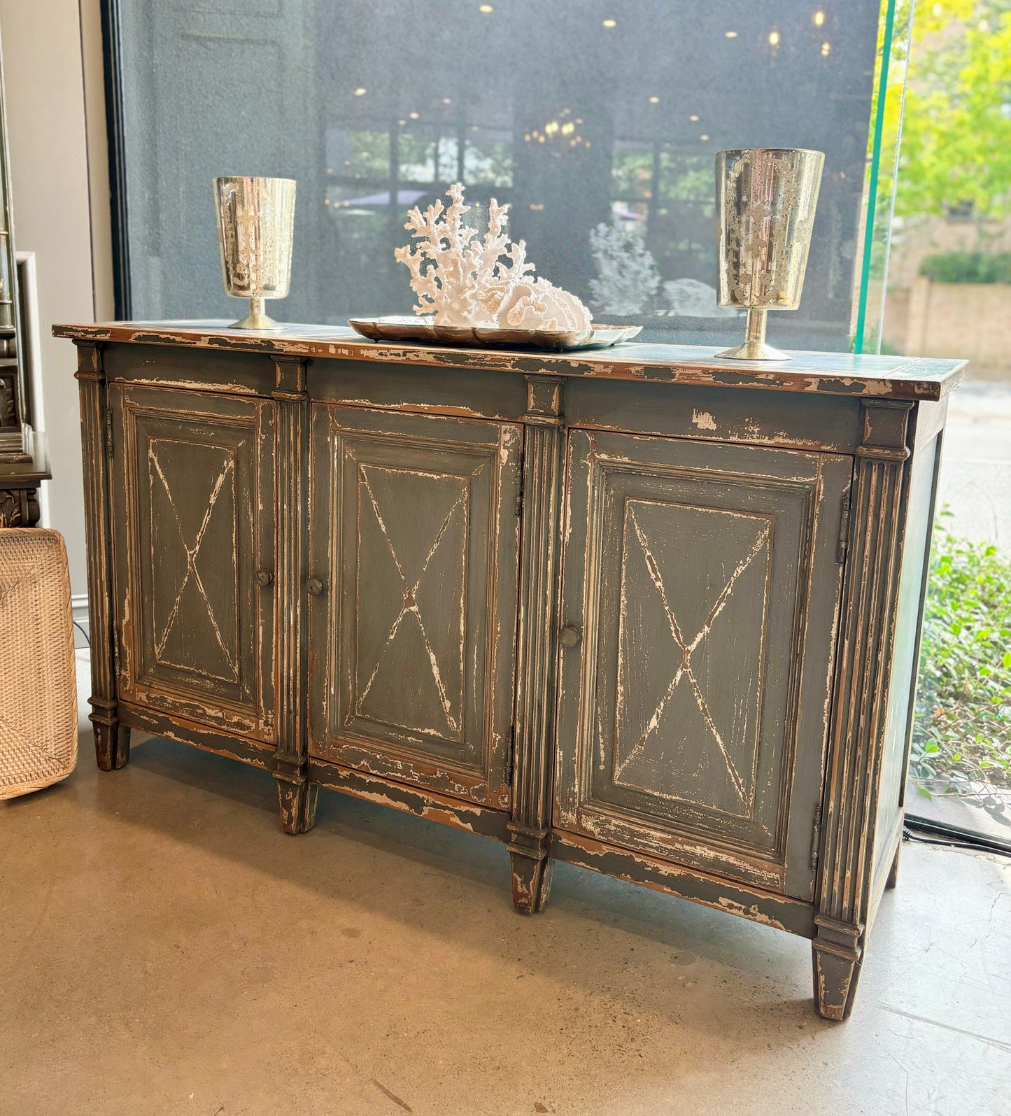 Meticulously crafted from reclaimed timber and adorned with a distressed blue paint finish, this one-of-a-kind sideboard adds versatility to any space. Whether in a dining room, bedroom, or elegant hallway, its three doors offer ample storage. Front