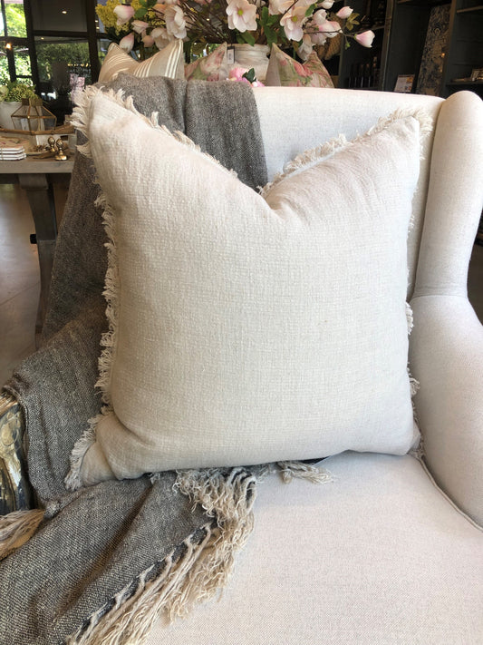 The Avril French Linen Fringed Edge Flax Cushion boasts a custom-woven fabric. It is feather filled for a luxuriously comfortable experience and finished with a charming, rustic natural hue.