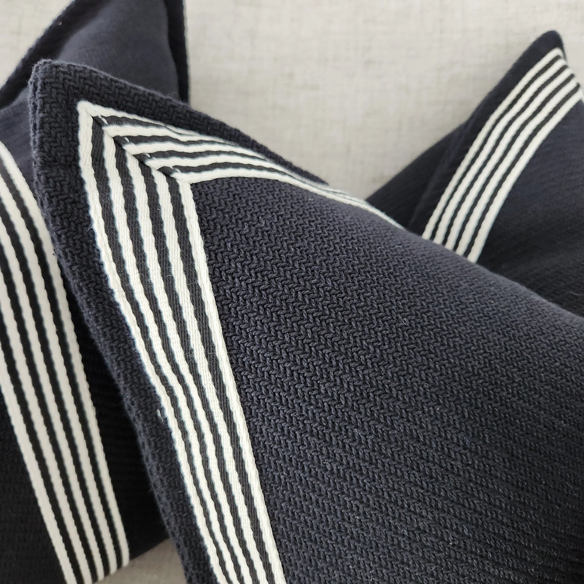 Channeling the sleek elegance of Milano's fashion district, each Black & White Herringbone Textured Cushion features the striking contrast of black and white, evoking the timeless beauty of the marble found in both ancient Italian villas and modern Milanese ateliers. Styled.