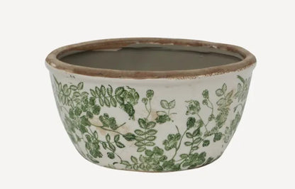 Experience the fresh ambiance of your indoor and outdoor spaces with the Green Botanical Print Pot. Lovingly crafted from stoneware and adorned with a delicate green botanical print, this pot exudes a natural charm that will surely uplift your surroundings. detail