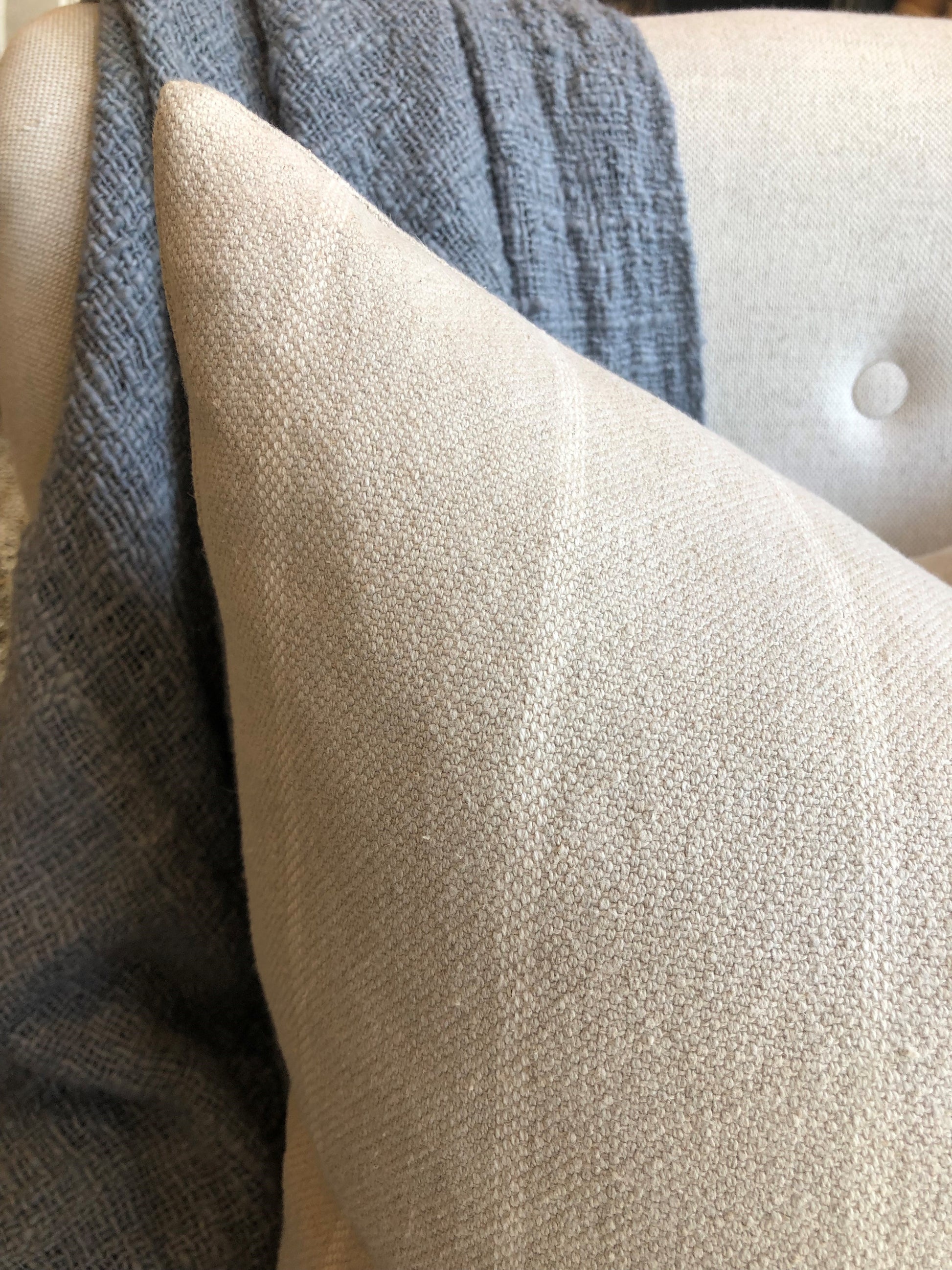 Experience the inviting warmth and rustic charm of your home with the Stéphane Striped Linen Cushion. This beautifully crafted cushion combines 60% linen and 40% cotton fabric, adorned with a simplified traditional pattern, and includes a discreet hidden zipper. Indulge in the perfect fusion of comfort and style. Corner close up.