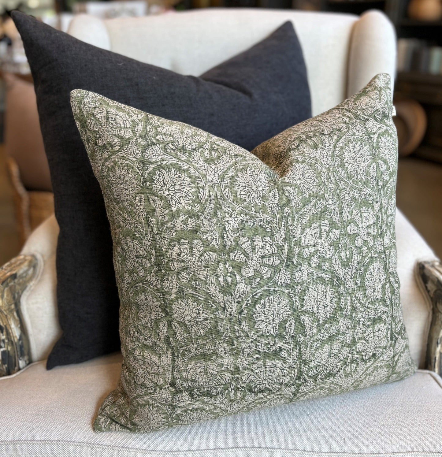 Introducing the Paradise Block Printed Linen Green Cushion crafted by Chamois, a renowned Swedish interior and fashion brand. This stunning addition to your home decor features a traditional Indian block print in a dark blue and natural hue pattern, and is made with 100% Belgian Linen for its superior quality and durability. To ensure maximum comfort, a quality feather insert is also included.