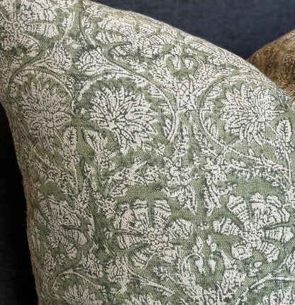 Introducing the Paradise Block Printed Linen Green Cushion crafted by Chamois, a renowned Swedish interior and fashion brand. This stunning addition to your home decor features a traditional Indian block print in a dark blue and natural hue pattern, and is made with 100% Belgian Linen for its superior quality and durability. To ensure maximum comfort, a quality feather insert is also included.