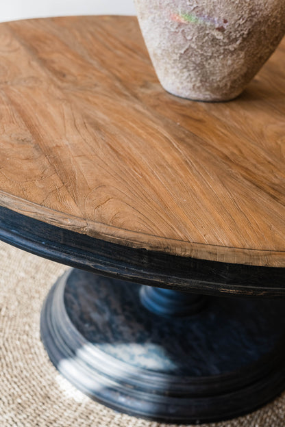 Our Remy Table is crafted from durable teak wood, boasting a round shape that is suitable for both indoor and outdoor use. Its unique carved leg design gives it a timeless, two-toned look that will elevate any space. With its solid construction and classic aesthetic, this round dining table is a perfect choice for those seeking a long-lasting elegant style. Detail