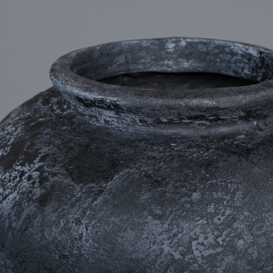 Black terracotta vase on a gray background