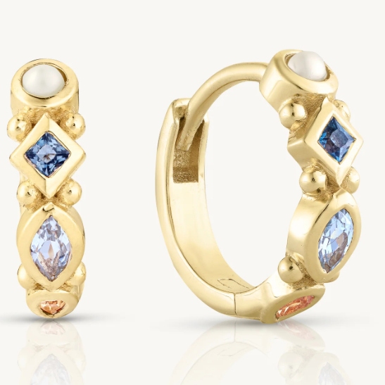 The Alida Topaz Huggies pack a real punch with hand-picked gemstones. You get a lustrous pearl, deep London blue topaz, sky blue marquise topaz, and warm citrine - all bezel-set into a golden hoop.&nbsp;