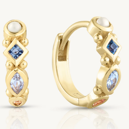 The Alida Topaz Huggies pack a real punch with hand-picked gemstones. You get a lustrous pearl, deep London blue topaz, sky blue marquise topaz, and warm citrine - all bezel-set into a golden hoop.&nbsp;