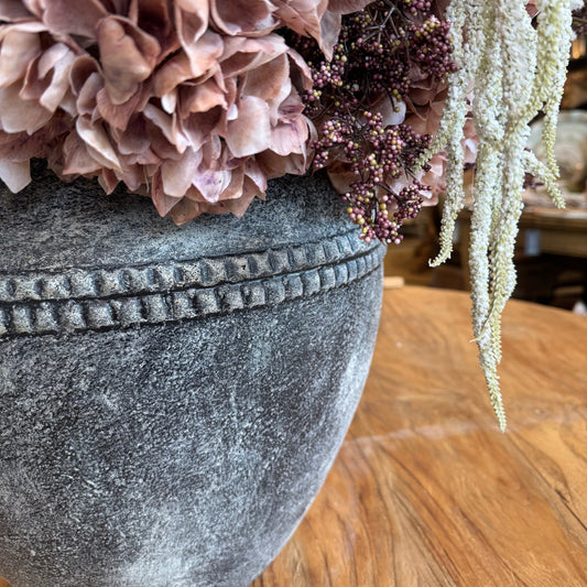 Decorative stone with flowers and a wooden surface
