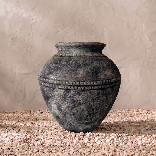 Decorative vase on a textured surface with a neutral background