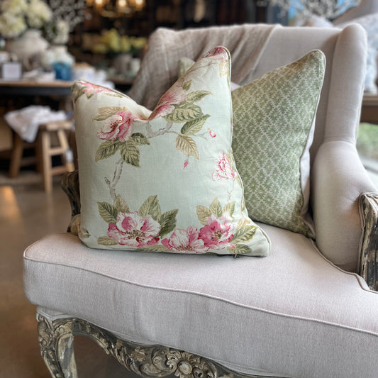 Experience the charm of the Ava Floral Print Linen Cushion - a favorite among our team. The delicate blend of sage green leaves and blush pink petals on a subtle, soft green background creates an elegant and beautiful addition to any space. Second Close-Up