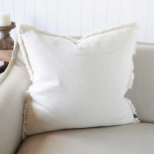 Crafted from 100% European Linen, the Avery White Linen Cushion boasts a cotton fringing and a plush feather insert for unmatched comfort. OEKO-TEX® and GOTS certifications add to its appeal.