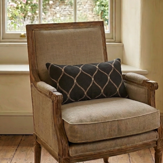 Chair with a cushion in a room with a window and fireplace