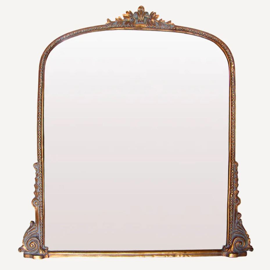 Decorative mirror with an ornate frame on a white background