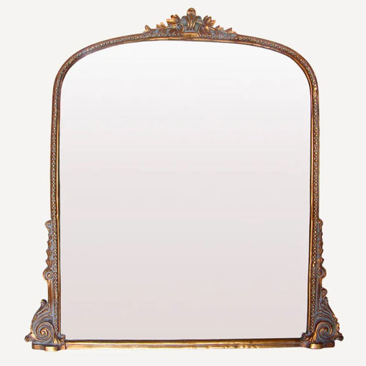 Decorative mirror with an ornate frame on a white background