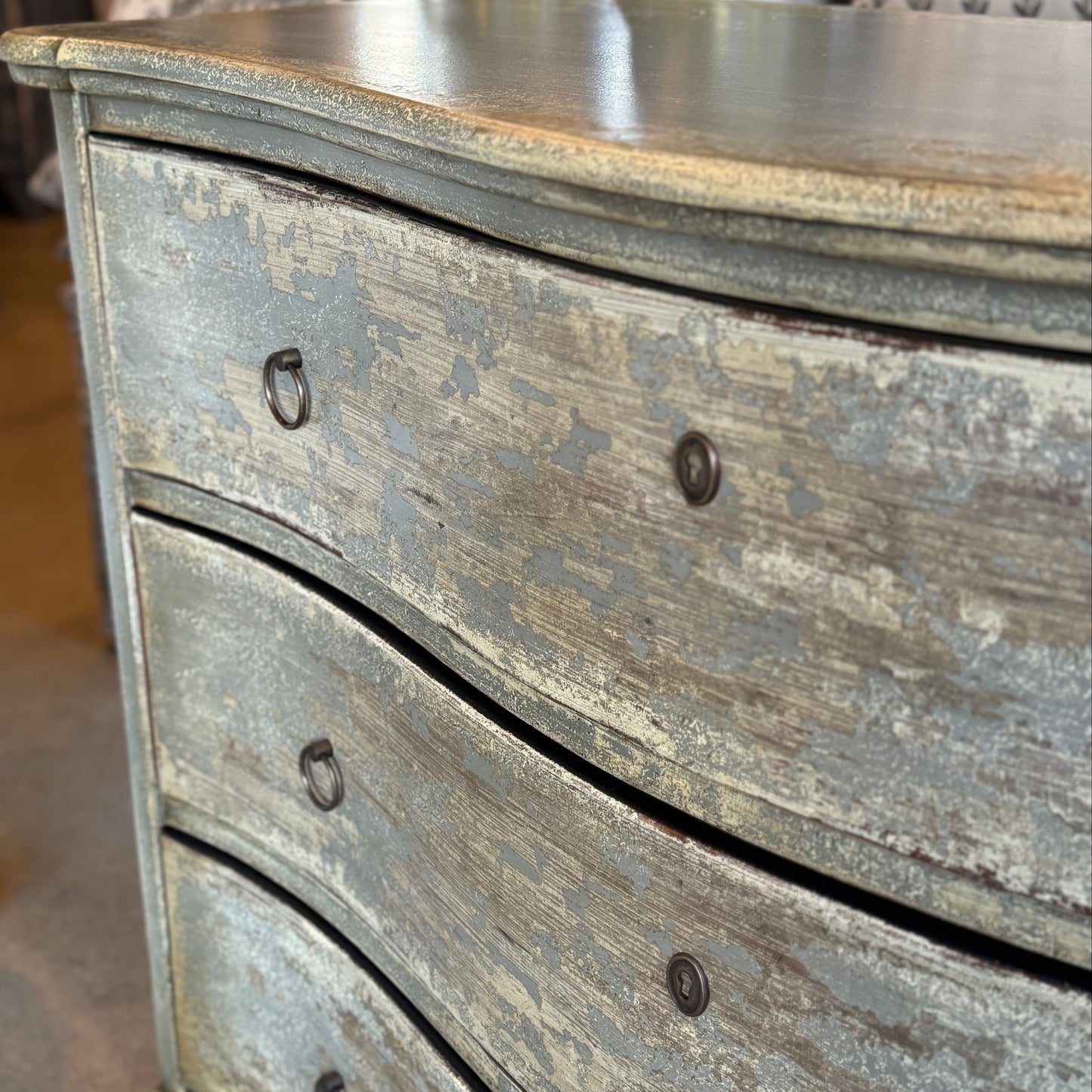 Wooden dresser with a distressed finish in a store setting