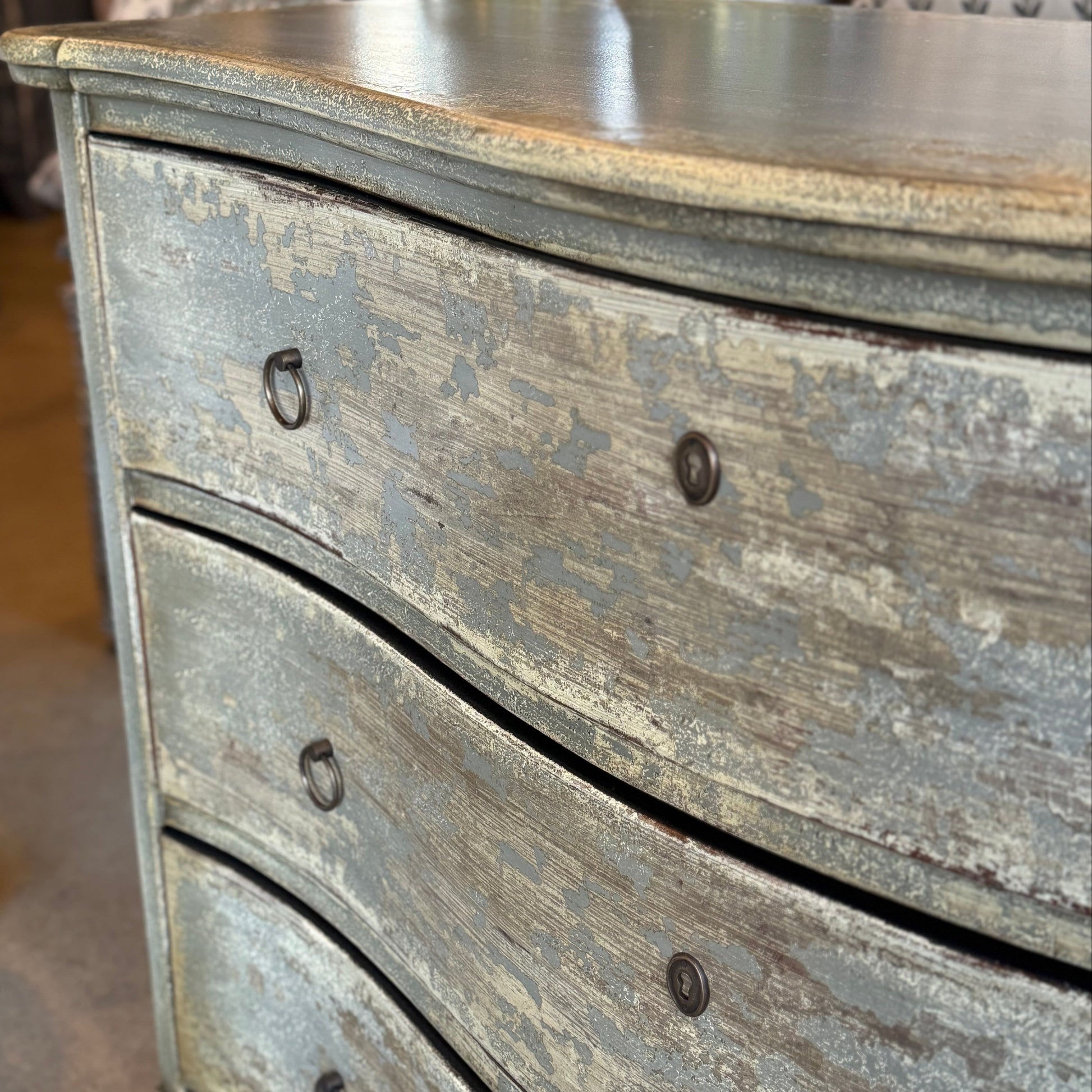 Wooden dresser with a distressed finish in a store setting