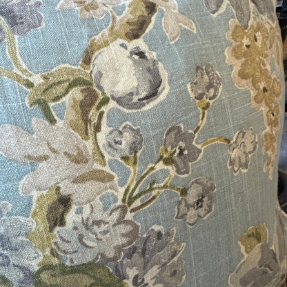 Floral patterned cushion with a blue background