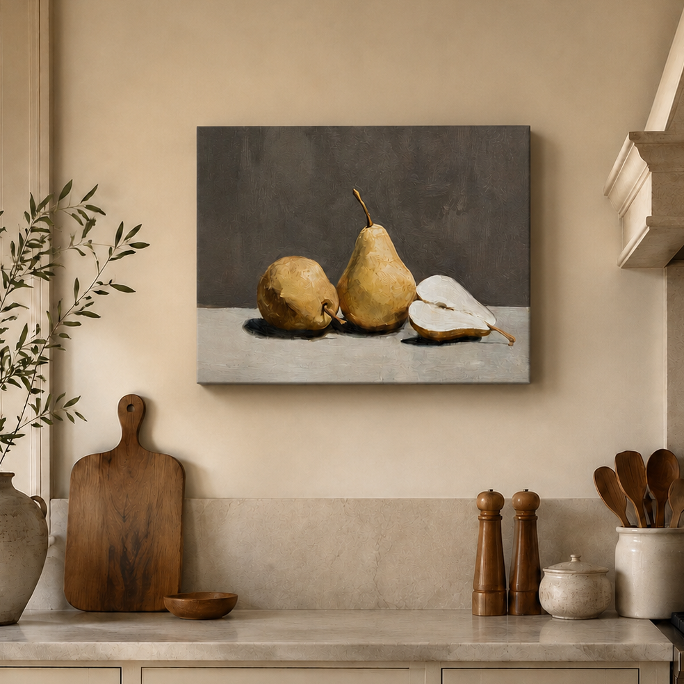 A rectangular wall art print showing a still life of two pears and a pear slice on a gray and white surface, hung above a kitchen counter with a vase, cutting board, salt and pepper shakers, and utensils.