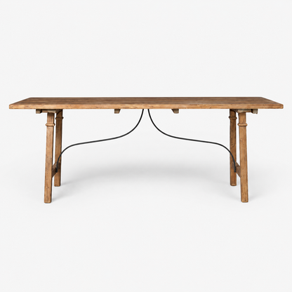 A rustic wooden dining table with a medium brown wood grain finish and a black metal wire apron connecting the legs, shown against a plain white background.