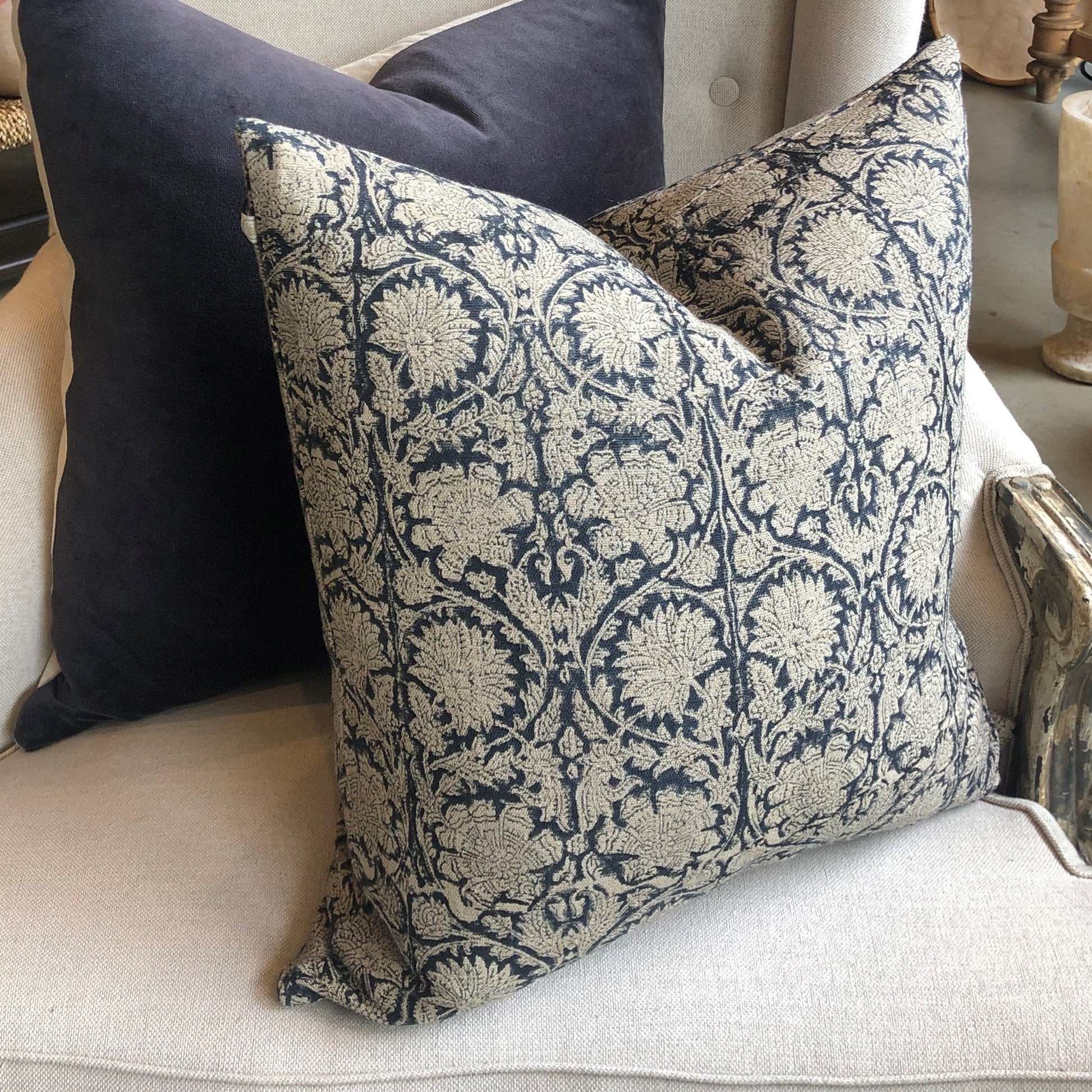 Introducing the Paradise Linen Dark Blue Cushion crafted by Chamois, a renowned Swedish interior and fashion brand. This stunning addition to your home decor features a traditional Indian block print in a dark blue and natural hue pattern, and is made with 100% Belgian Linen for its superior quality and durability. To ensure maximum comfort, a quality feather insert is also included.