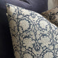 Introducing the Paradise Linen Dark Blue Cushion crafted by Chamois, a renowned Swedish interior and fashion brand. This stunning addition to your home decor features a traditional Indian block print in a dark blue and natural hue pattern, and is made with 100% Belgian Linen for its superior quality and durability. To ensure maximum comfort, a quality feather insert is also included. Close up corner.