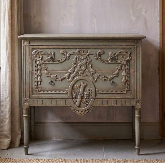 Decorative wooden cabinet in a room with a window and open door.