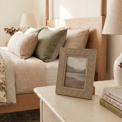 Cozy bedroom with a bed, nightstands, and decorative items.