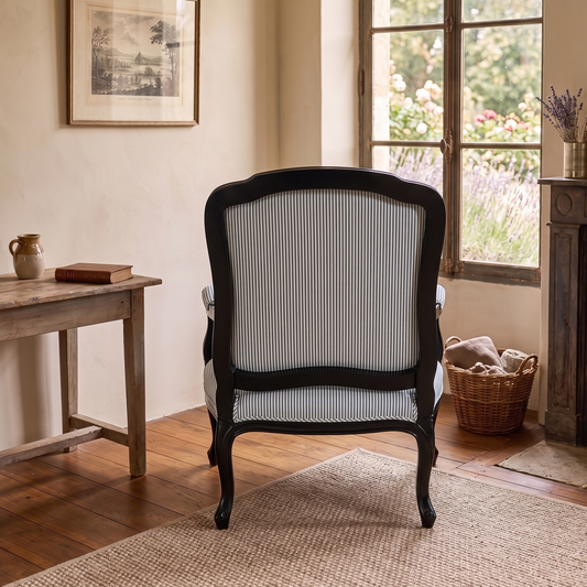 Chair in a room with a window, table, and basket