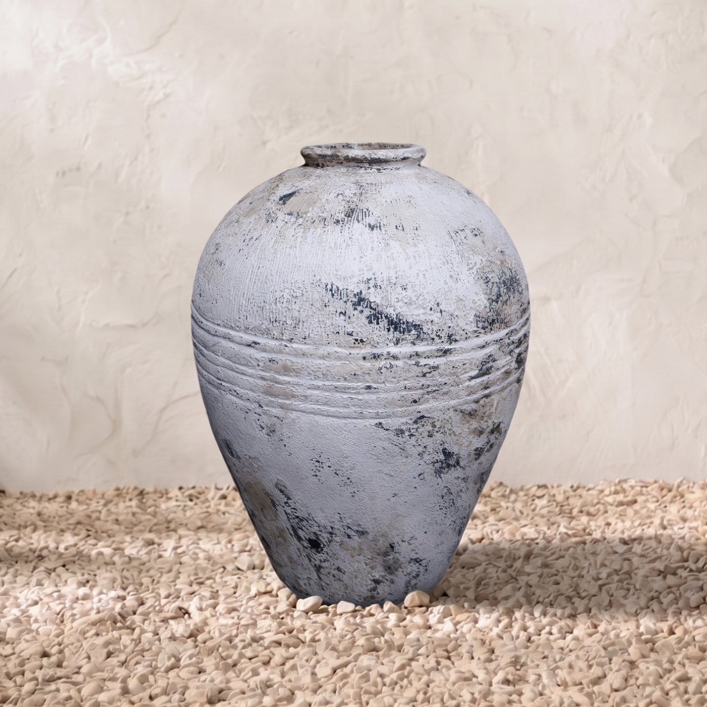 Distressed white and grey pot with textured surface