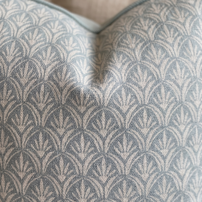 Close-up of a textured fabric with a geometric pattern on a pillow.