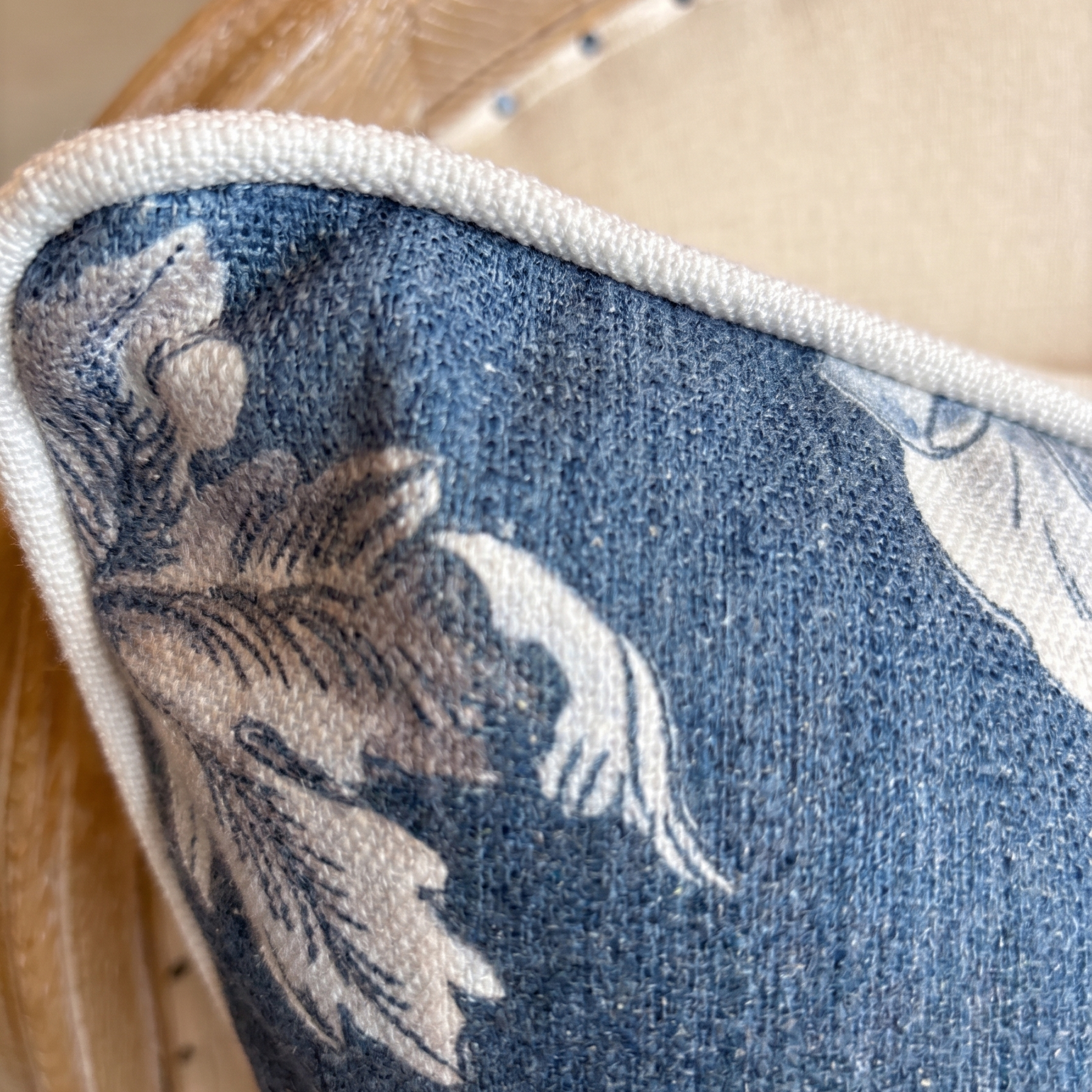 Close-up of a blue floral-patterned cushion on a chair
