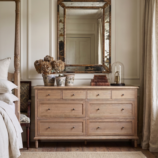 Bedroom with wooden four-poster bed and dresser, featuring decorative items.