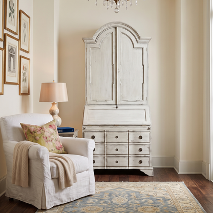 Living room with white armchair, armoire, and chandelier
