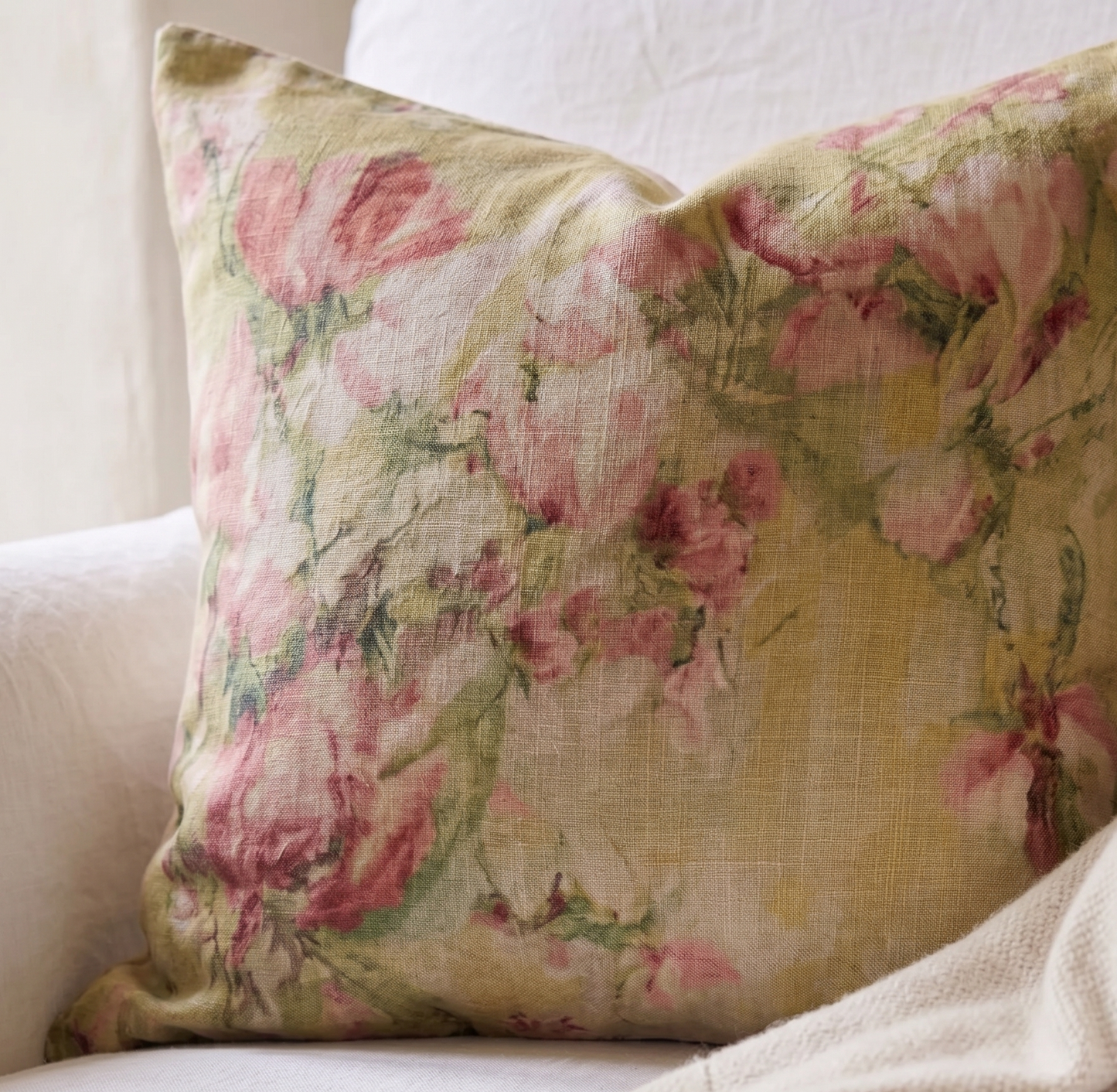 Floral patterned pillow on a white sofa