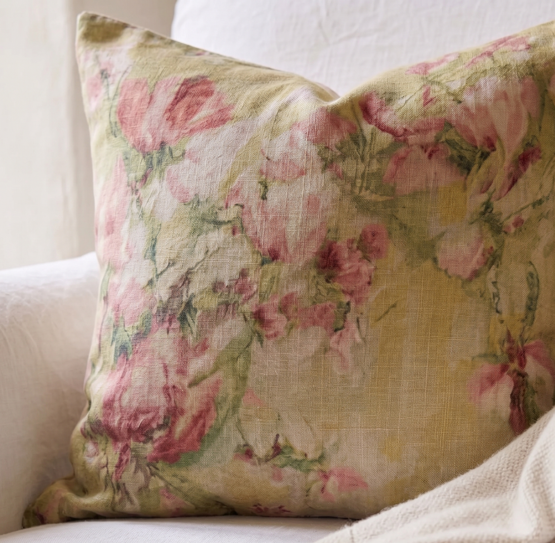 Floral patterned pillow on a white sofa