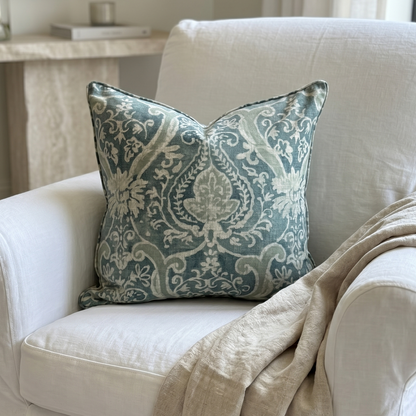 Decorative pillow on a white armchair with a neutral color scheme