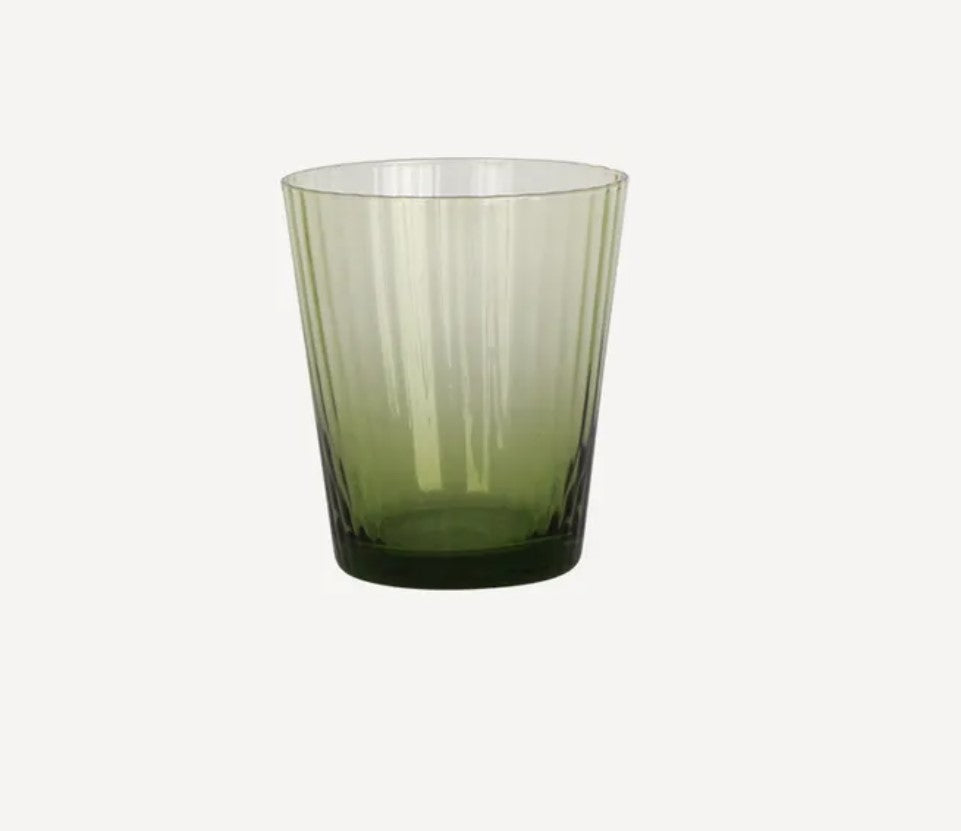 A green ribbed glass tumbler with a transparent rim.