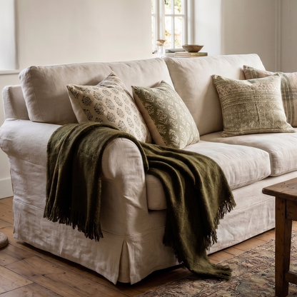 Cozy living room with a beige sofa, wooden coffee table, and decorative elements.