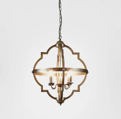 A hanging pendant light fixture with a distressed bronze metal frame, featuring a quatrefoil-style outer border and a central ring with candle-style bulbs, shown against a plain light gray background.