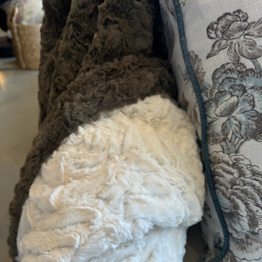 Indulge in ultimate warmth and coziness with the Hadlee Soft Throw. Its luxurious texture adds a touch of character to any bedding or sofa, easily pairing with other textiles. The rich olive colour adds depth and an inviting atmosphere to any space, making you feel right at home. It's also reversible, with an elegant olive hue on one side and a soft ivory on the other. For added convenience, simply toss it in the washing machine on a cold cycle.