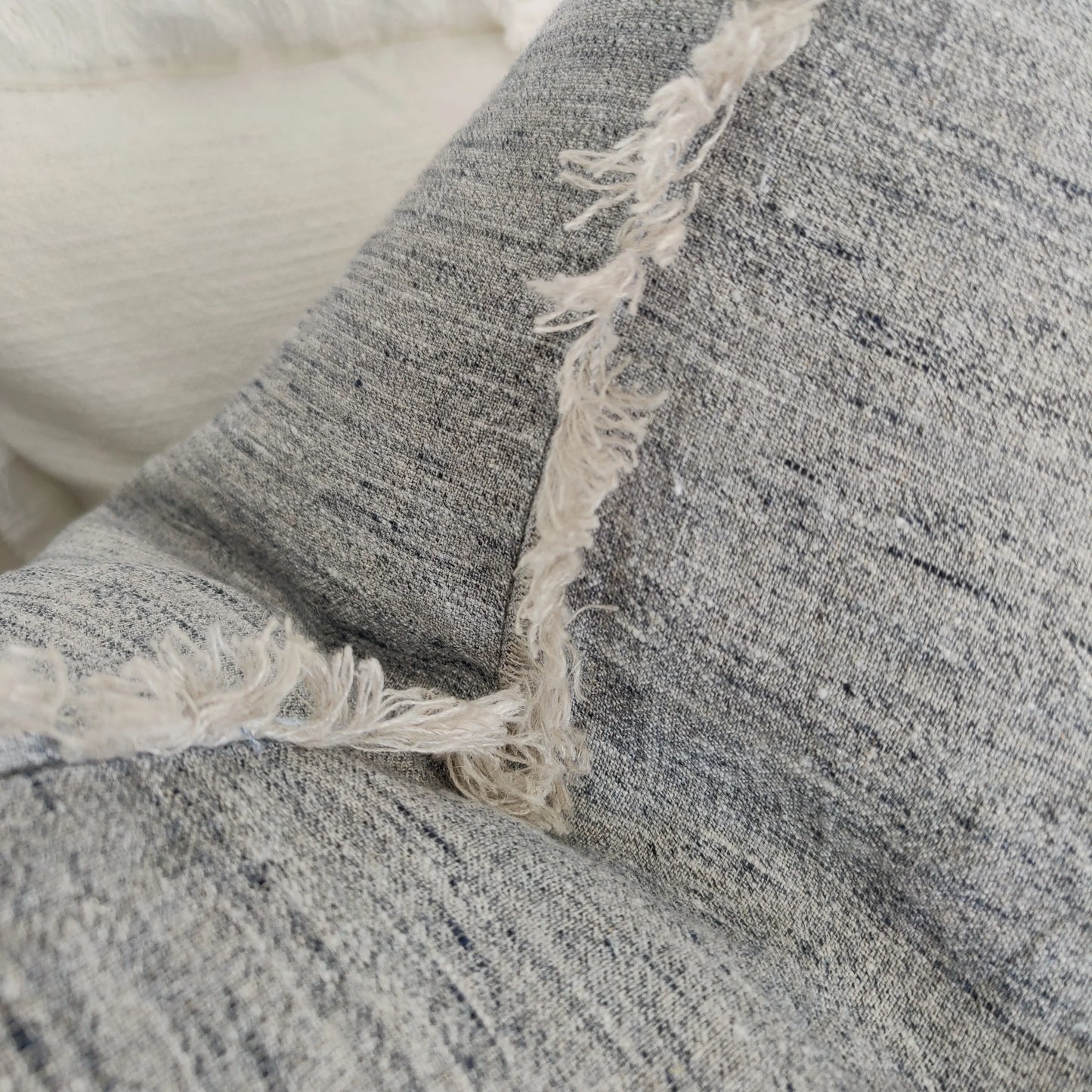 Experience the ultimate in luxury with our Grey Linen Fringed Cushion. Crafted from the finest quality French linen, this cushion radiates an air of elegance and refinement. Its lovely fringed detail adds just the right amount of texture to any room. Detail.