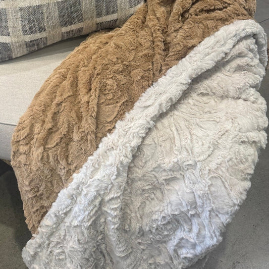 Transform any bedding or sofa into a cozy oasis with the Caramel &amp; Ivory Soft Throw. Its opulent texture adds charm to any space, effortlessly complementing other fabrics. The neutral hue, easy to match with varying tones, creates an inviting ambiance that will make you feel right at home. Plus, it's machine washable on a cold cycle for your convenience.
