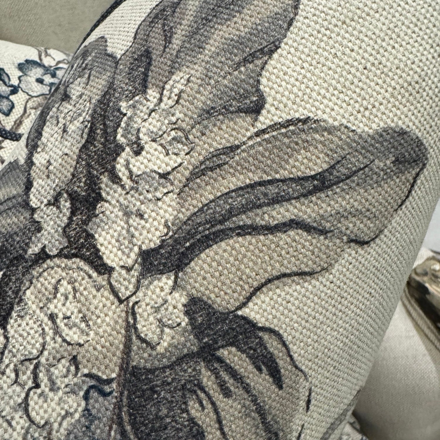 Revitalize your interior with the Warwick Grey Floral Linen &amp; Cotton Cushion, crafted from premium fabric by the distinguished Warwick Fabrics. The exquisite floral pattern in sophisticated grey and taupe tones creates a striking contrast against its neutral base, commanding attention in any room. This sumptuous cushion effortlessly enhances sofas, chairs, or bedding while delivering exceptional comfort with its lavish feather filling. An irresistible statement piece that elevates your home's ambiance