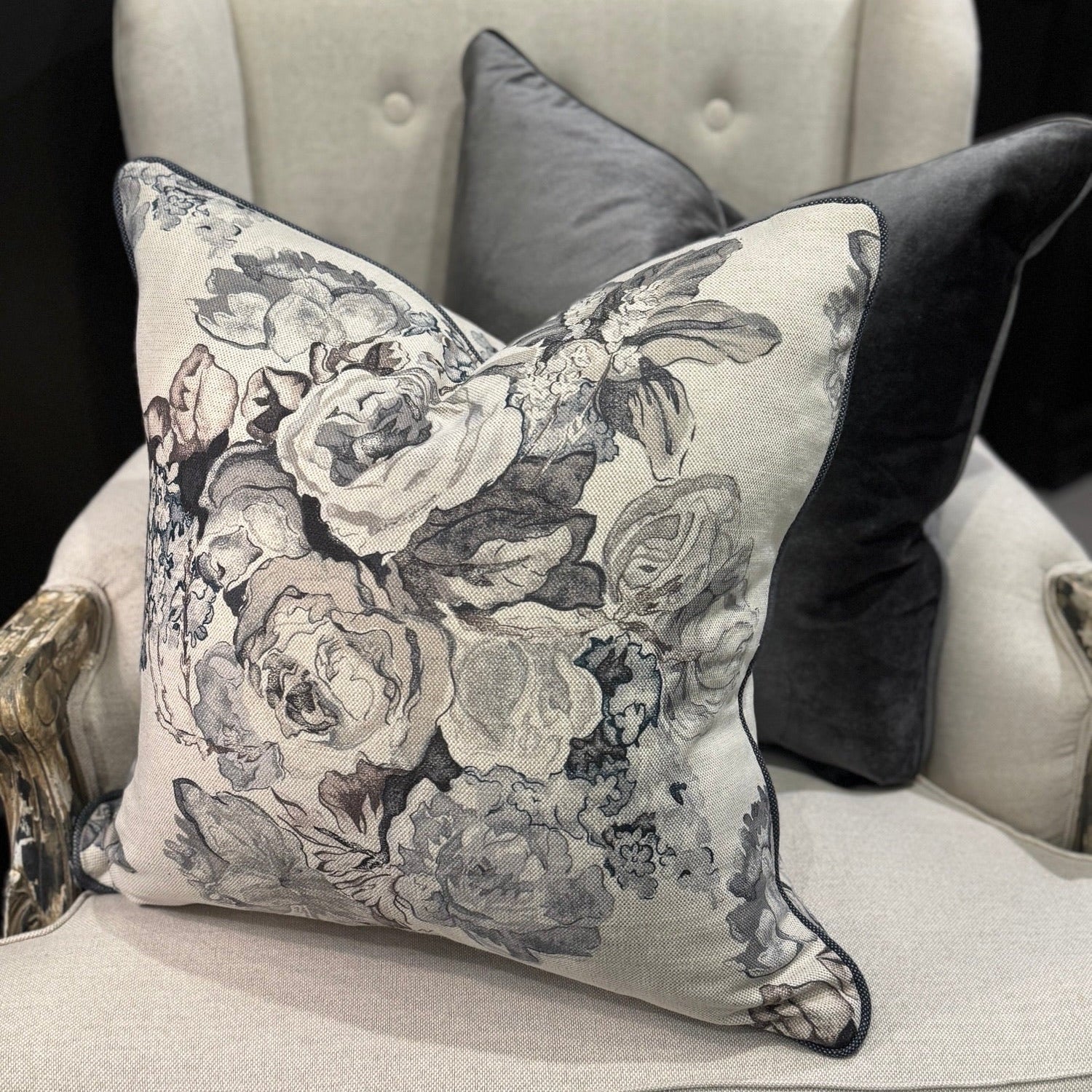 Revitalize your interior with the Warwick Grey Floral Linen &amp; Cotton Cushion, crafted from premium fabric by the distinguished Warwick Fabrics. The exquisite floral pattern in sophisticated grey and taupe tones creates a striking contrast against its neutral base, commanding attention in any room. This sumptuous cushion effortlessly enhances sofas, chairs, or bedding while delivering exceptional comfort with its lavish feather filling. An irresistible statement piece that elevates your home's ambiance