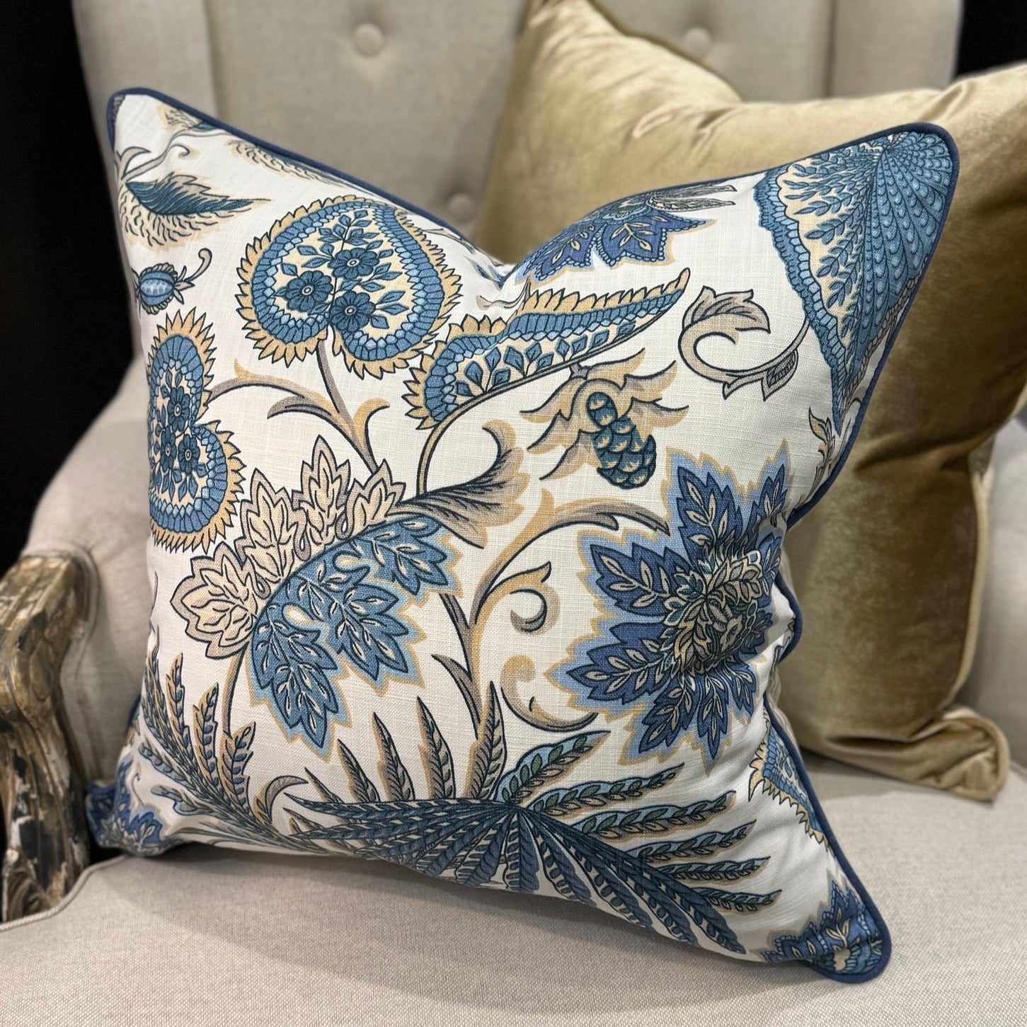 Elevate your interior with the Emily Blue &amp; Taupe Floral Cushion, masterfully crafted using superior fabrics. The sophisticated floral pattern displays captivating blue and taupe hues on a pristine ivory canvas, drawing admiring glances in any setting. Flip to reveal a refined ochre ticking stripe complemented by rich deep blue piping for versatile styling options. 