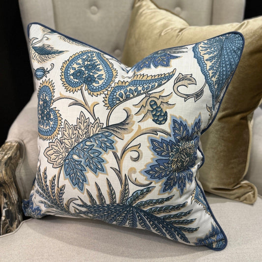 Elevate your interior with the Emily Blue &amp; Taupe Floral Cushion, masterfully crafted using superior fabrics. The sophisticated floral pattern displays captivating blue and taupe hues on a pristine ivory canvas, drawing admiring glances in any setting. Flip to reveal a refined ochre ticking stripe complemented by rich deep blue piping for versatile styling options. 