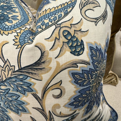 Elevate your interior with the Emily Blue &amp; Taupe Floral Cushion, masterfully crafted using superior fabrics. The sophisticated floral pattern displays captivating blue and taupe hues on a pristine ivory canvas, drawing admiring glances in any setting. Flip to reveal a refined ochre ticking stripe complemented by rich deep blue piping for versatile styling options. 